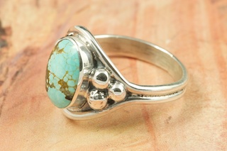Genuine Number 8 Turquoise set in Sterling Silver Ring. The Number 8 mine is located in Eureka County Nevada. Since 1976 there has been no Number 8 Turquoise mined. There is however, an existing stock pile that Mr. Dowell Ward, the last owner of the Number 8 mine, had stocked away for later sorting. The Turquoise is a collector's item--because once the reserve is gone there will be no more material released onto the market. The Gold Mining Company owns the claim to the Number 8 mine and it has been swallowed up by the gold mining operations. This is some of the last Number 8 Turquoise to be had and will be a great addition to your collection. Created by Navajo Artist Bobby Piaso. Signed by the artist.